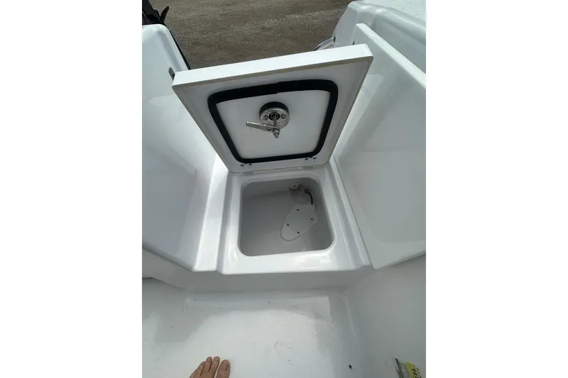 Slide: The Image of 2026 Sportsman Open 232 Center Console storage compartment with open hatch. - 10