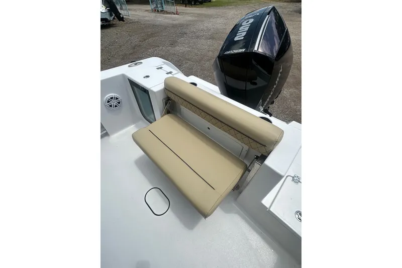 Slide: The Image of 2026 Sportsman Open 232 Center Console boat with tan seating and Mercury engine. - 12