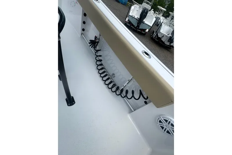 Slide: The Image of 2026 Sportsman Open 232 Center Console boat interior with coiled hose and speaker. - 15