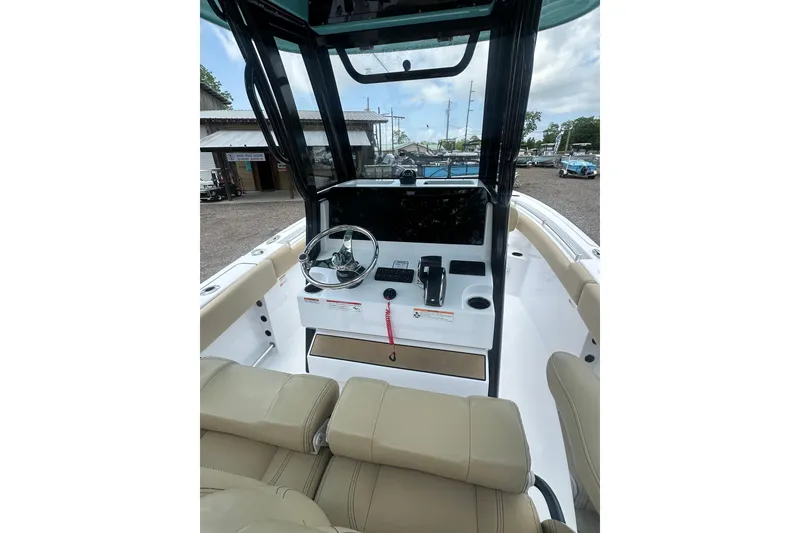 Slide: The Image of 2026 Sportsman Open 232 Center Console boat interior with steering wheel and controls. - 16