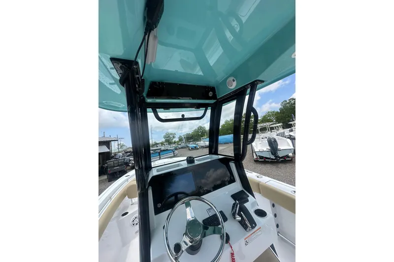 Slide: The Image of 2026 Sportsman Open 232 Center Console boat interior with steering wheel and control panel. - 18