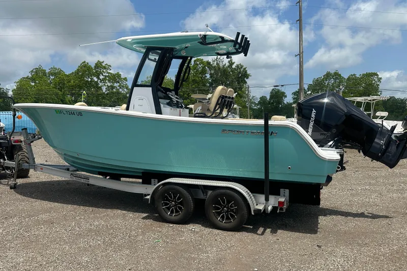 Slide: The Image of 2026 Sportsman Open 232 Center Console boat on trailer, parked outdoors. - 2