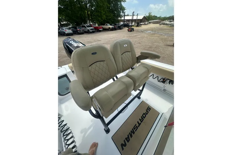 Slide: The Image of 2026 Sportsman Open 232 Center Console boat with beige seating and outdoor setting. - 20
