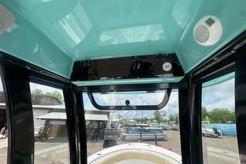 Slide: The Image of Interior view of 2026 Sportsman Open 232 Center Console boat, showcasing helm and windshield. - 23