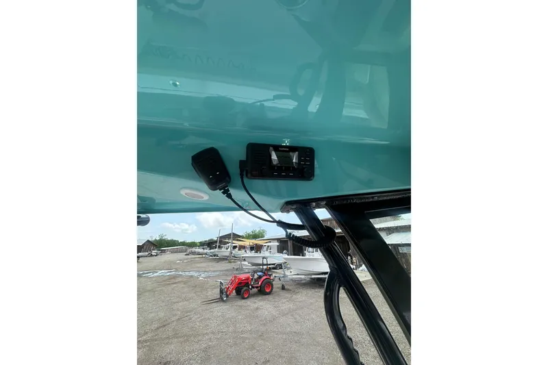 Slide: The Image of 2026 Sportsman Open 232 Center Console boat interior with Garmin device and microphone. - 24