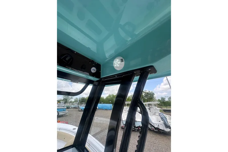 Slide: The Image of 2026 Sportsman Open 232 Center Console boat interior with teal ceiling and black supports. - 27