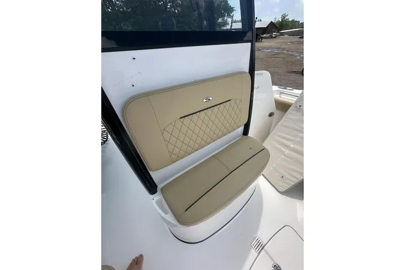 Slide: The Image of 2026 Sportsman Open 232 Center Console boat with tan cushioned seating. - 28