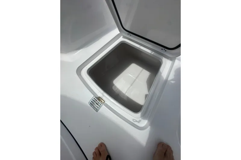 Slide: The Image of Open storage compartment on 2026 Sportsman Open 232 Center Console boat. - 30