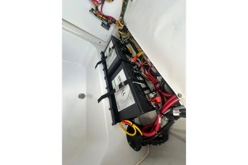 Slide: The Image of Battery compartment of 2026 Sportsman Open 232 Center Console with wiring. - 31