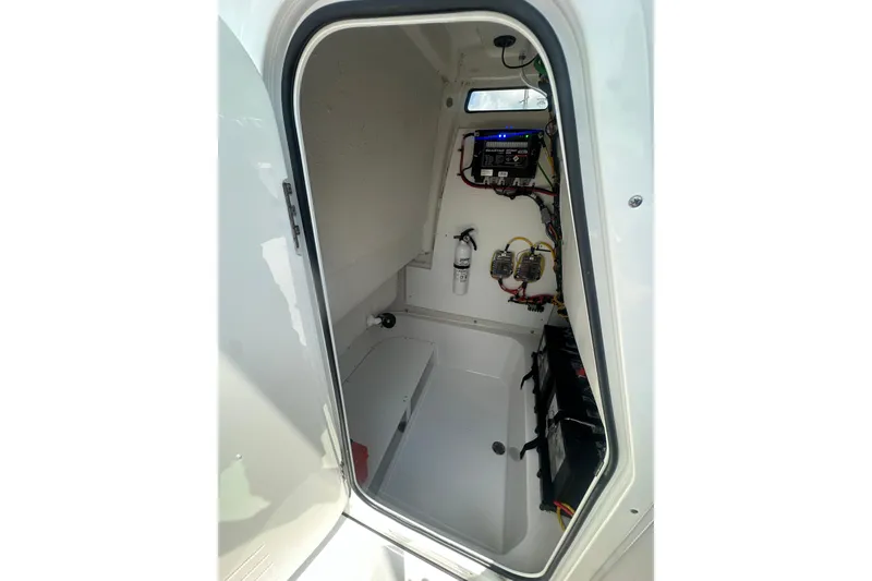 Slide: The Image of Interior view of 2026 Sportsman Open 232 Center Console boat's electrical compartment. - 34