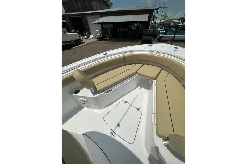 Slide: The Image of 2026 Sportsman Open 232 Center Console boat with tan seating and spacious deck. - 37