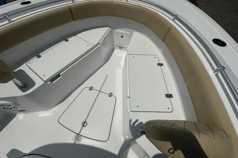 Slide: The Image of 2026 Sportsman Open 232 Center Console boat interior with cushioned seating and storage compartments. - 40