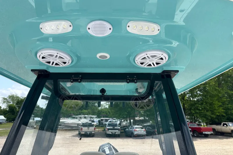 Slide: The Image of 2026 Sportsman Open 232 Center Console boat with speakers and lights on the canopy. - 42