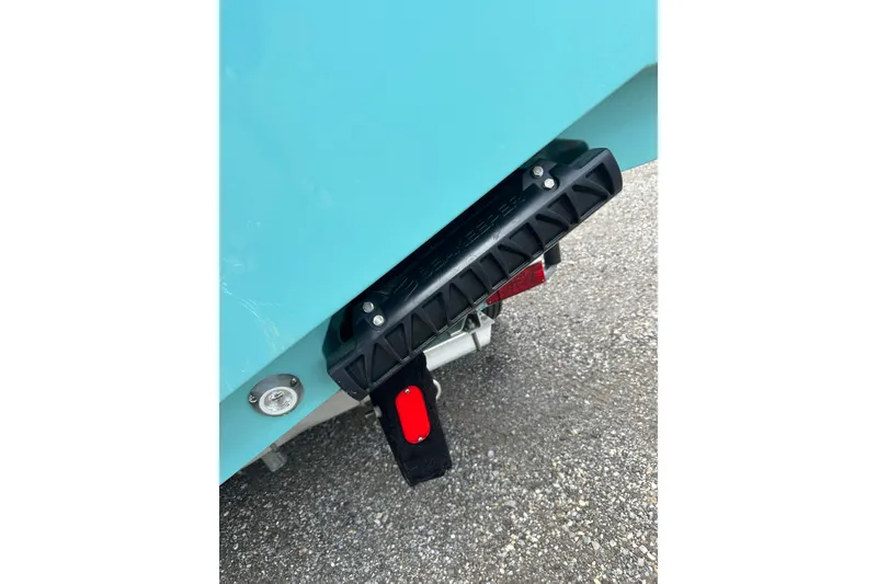 Slide: The Image of 2026 Sportsman Open 232 Center Console boat detail, featuring a black step and red reflector. - 44