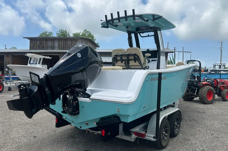 Slide: The Image of 2026 Sportsman Open 232 Center Console boat on trailer, featuring a powerful outboard motor. - 5