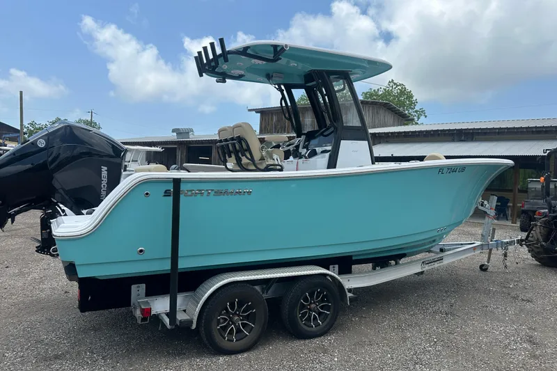 Slide: The Image of 2026 Sportsman Open 232 Center Console boat on trailer, turquoise hull, outdoor setting. - 6