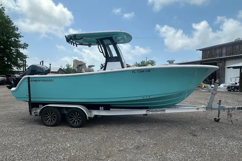 Slide: The Image of 2026 Sportsman Open 232 Center Console boat on trailer, parked outdoors. - 7