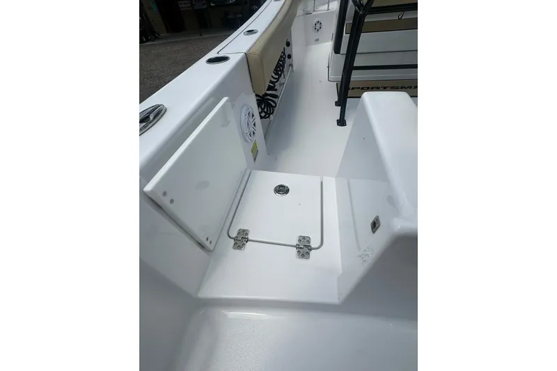 Slide: The Image of 2026 Sportsman Open 232 Center Console boat interior, featuring storage compartment and seating area. - 9