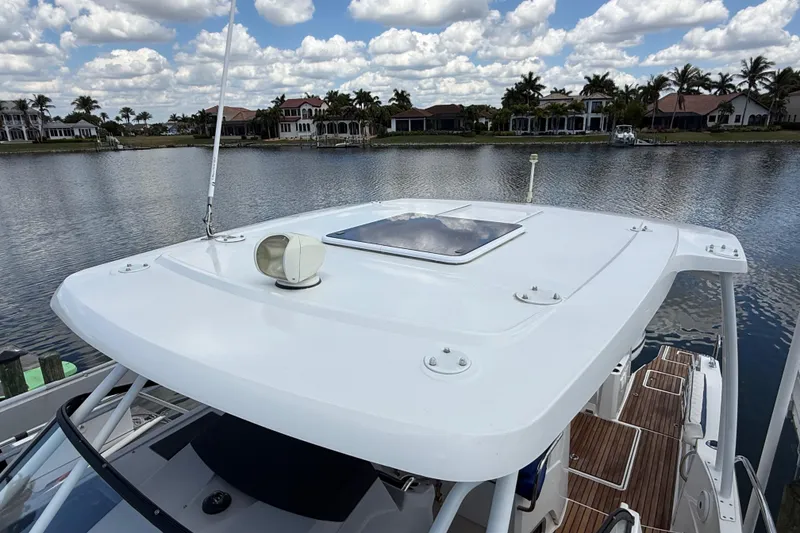 Slide: The Image of 2019 Jeanneau Leader 10.5 boat on a calm lake with scenic waterfront homes. - 101