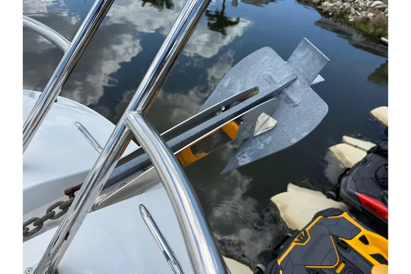 Slide: The Image of Anchor on Jeanneau Leader 10.5 boat, 2019 model, reflecting in calm water. - 104
