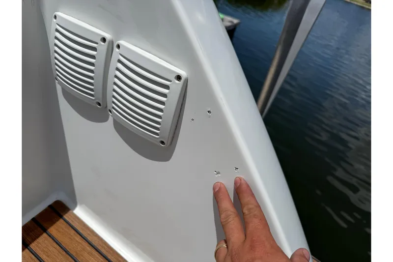 Slide: The Image of 2019 Jeanneau Leader 10.5 boat detail with vents and finger pointing at small holes. - 107