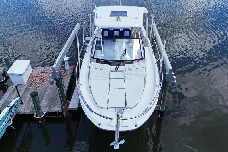 Slide: The Image of 2019 Jeanneau Leader 10.5 boat docked on calm water, aerial view. - 15