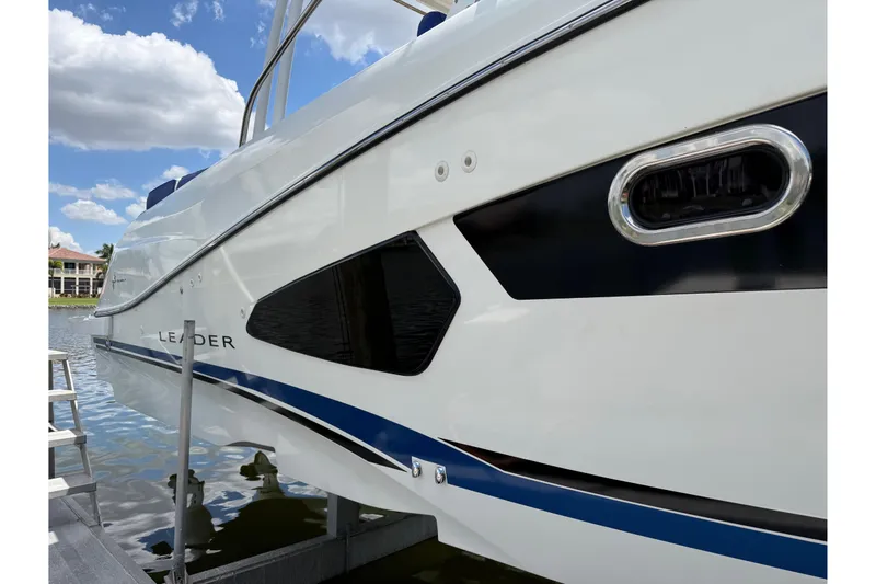Slide: The Image of 2019 Jeanneau Leader 10.5 boat docked, showcasing sleek design and modern features. - 16