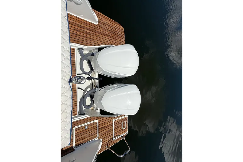 Slide: The Image of 2019 Jeanneau Leader 10.5 boat with twin outboard engines on teak deck. - 17
