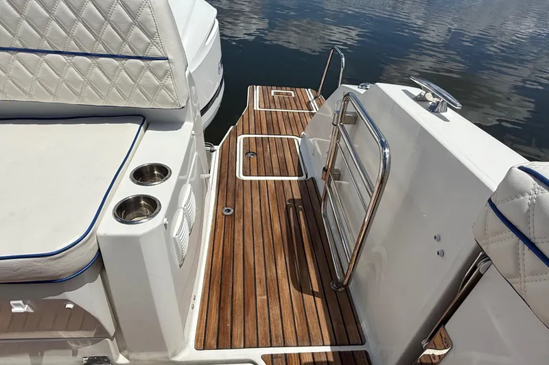 Slide: The Image of 2019 Jeanneau Leader 10.5 boat deck with teak flooring and cushioned seating. - 18