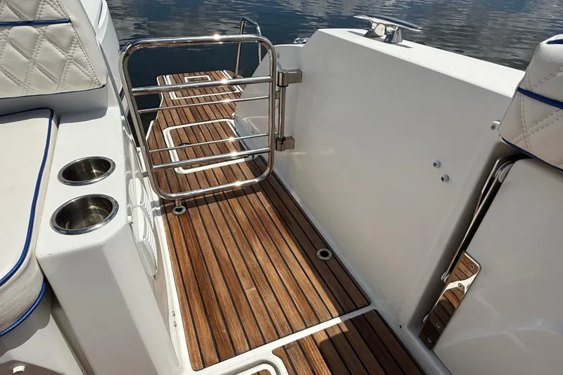 Slide: The Image of 2019 Jeanneau Leader 10.5 boat deck with teak flooring and stainless steel gate. - 19