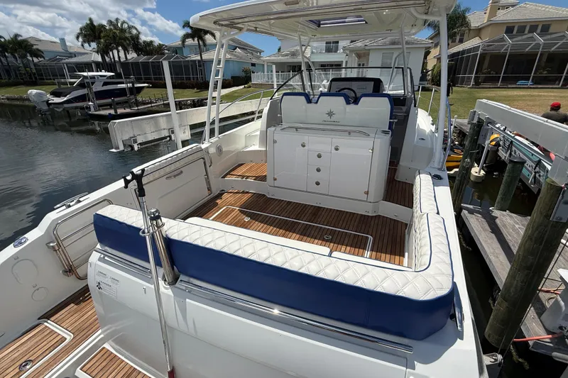 Slide: The Image of 2019 Jeanneau Leader 10.5 boat with spacious deck and luxurious seating at a dock. - 25