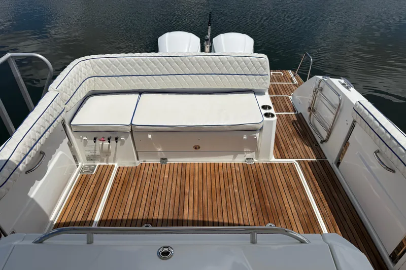 Slide: The Image of 2019 Jeanneau Leader 10.5 boat deck with cushioned seating and wooden flooring. - 31
