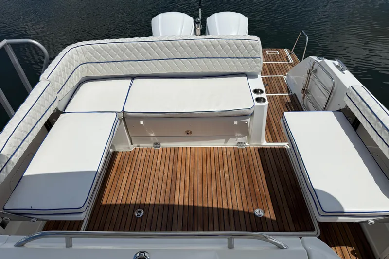 Slide: The Image of 2019 Jeanneau Leader 10.5 boat deck with cushioned seating and wooden flooring. - 32
