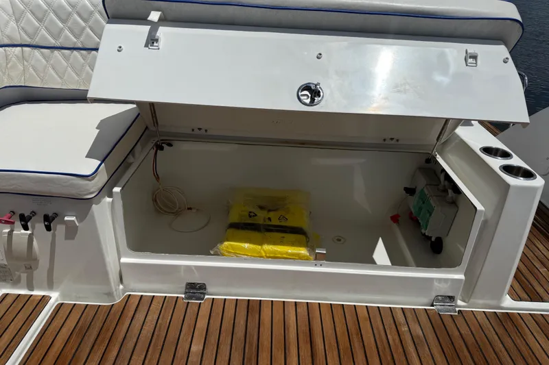 Slide: The Image of Open storage compartment on 2019 Jeanneau Leader 10.5 boat with cushioned seating. - 36
