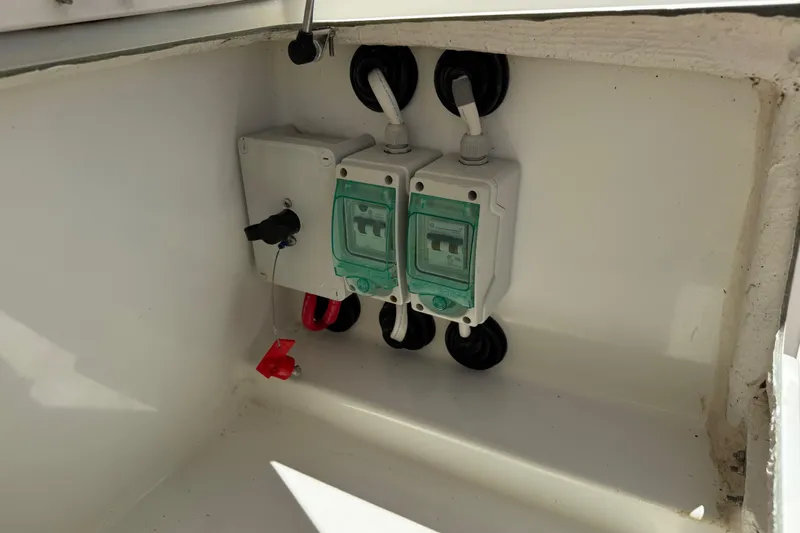 Slide: The Image of Electrical components inside a 2019 Jeanneau Leader 10.5 boat, featuring circuit breakers and wiring. - 37