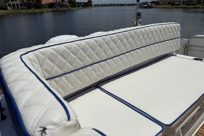 Slide: The Image of Luxurious seating on 2019 Jeanneau Leader 10.5 boat, overlooking serene waterway. - 38
