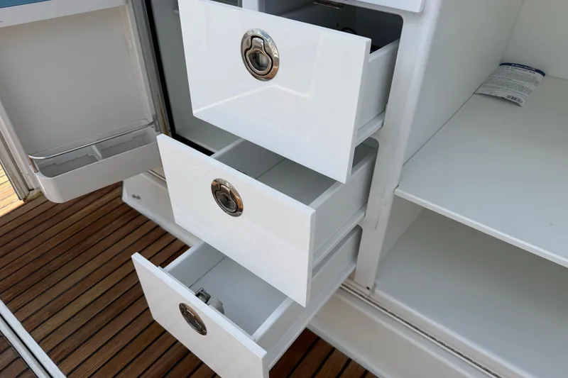 Slide: The Image of Open drawers and storage on a 2019 Jeanneau Leader 10.5 boat interior. - 40