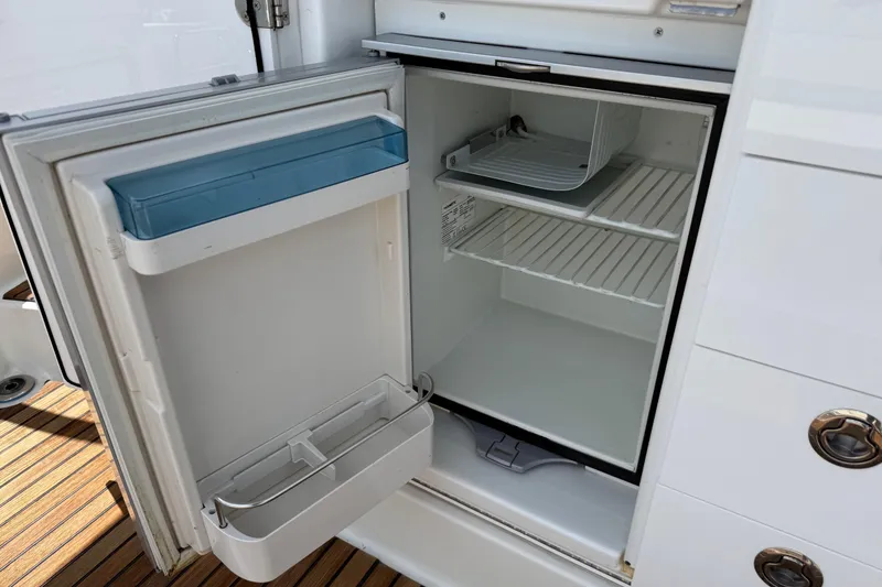 Slide: The Image of Open refrigerator on Jeanneau Leader 10.5 boat, 2019 model, with wooden deck flooring. - 41