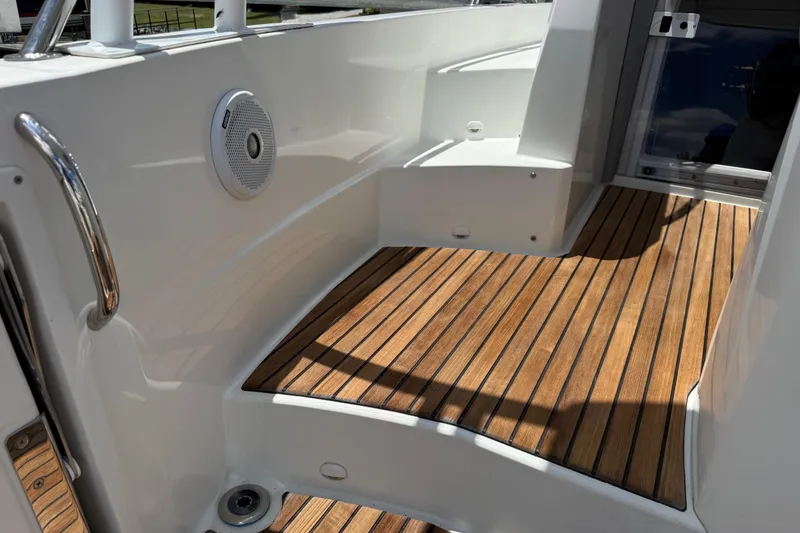 Slide: The Image of 2019 Jeanneau Leader 10.5 boat interior with teak flooring and built-in speaker. - 43
