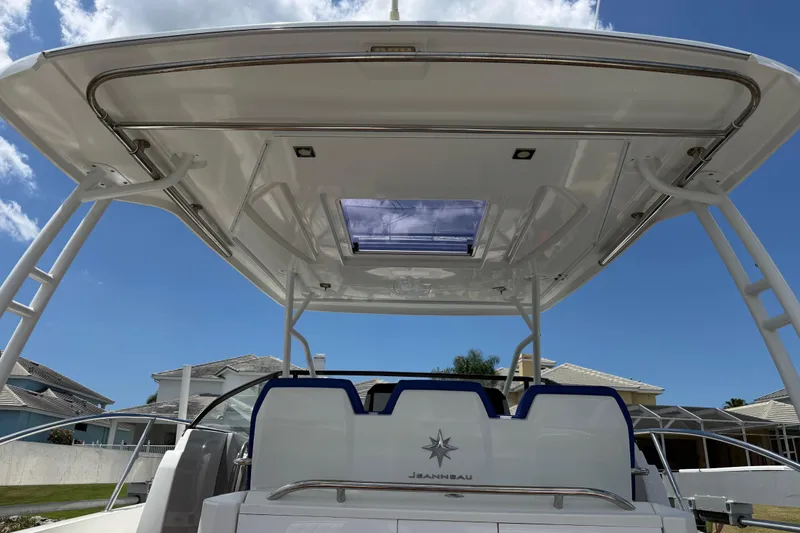 Slide: The Image of 2019 Jeanneau Leader 10.5 boat with sleek design and spacious deck under blue sky. - 45