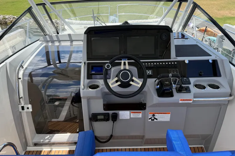 Slide: The Image of Cockpit of 2019 Jeanneau Leader 10.5 boat with steering wheel and control panel. - 51