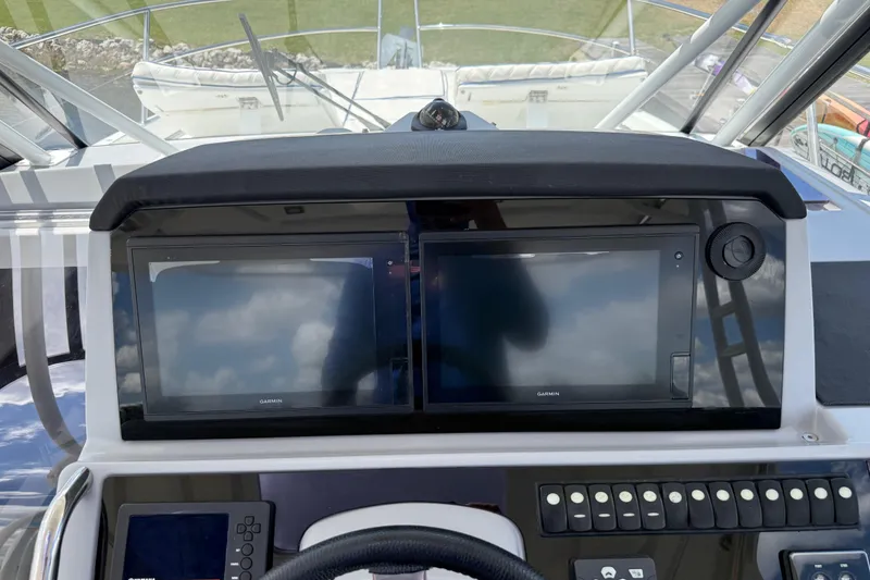 Slide: The Image of Helm of 2019 Jeanneau Leader 10.5 with dual Garmin displays and control panel. - 53