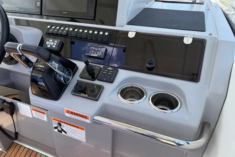 Slide: The Image of Control panel of 2019 Jeanneau Leader 10.5 boat with steering and navigation controls. - 54