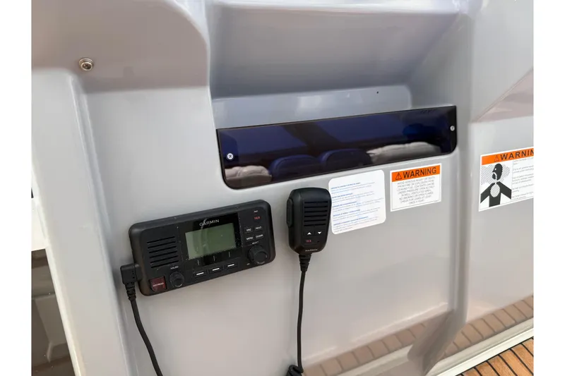 Slide: The Image of Garmin radio system on 2019 Jeanneau Leader 10.5 boat dashboard with warning labels. - 60