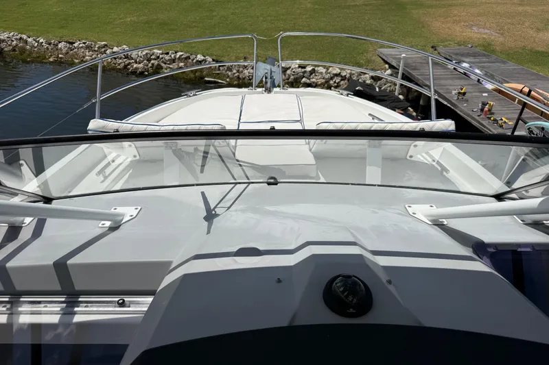 Slide: The Image of 2019 Jeanneau Leader 10.5 boat docked near a grassy shoreline. - 68