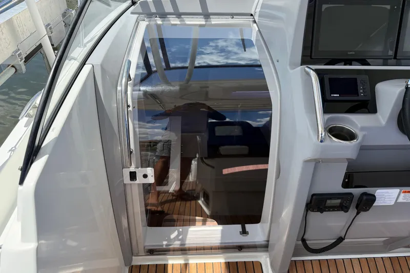 Slide: The Image of 2019 Jeanneau Leader 10.5 cockpit with glass door and control panel. - 69
