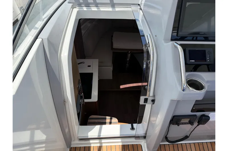 Slide: The Image of 2019 Jeanneau Leader 10.5 cabin entrance with modern controls and teak flooring. - 70
