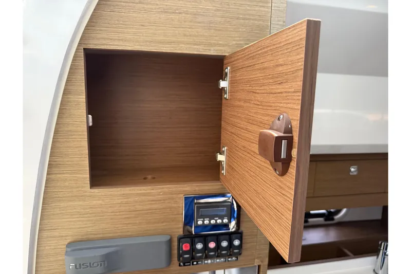 Slide: The Image of Open wooden cabinet on 2019 Jeanneau Leader 10.5 boat, showcasing interior storage space. - 76