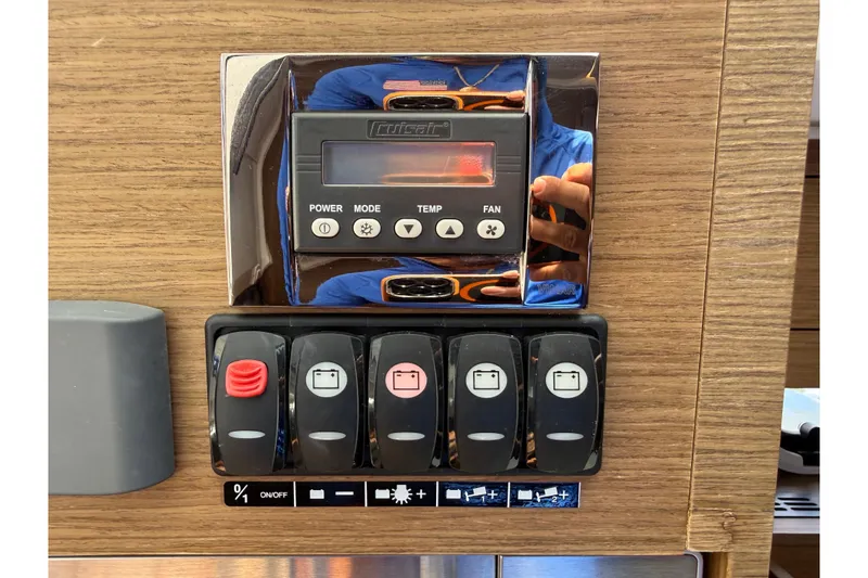 Slide: The Image of Control panel on 2019 Jeanneau Leader 10.5 boat with switches and digital display. - 78