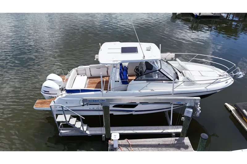Slide: The Image of 2019 Jeanneau Leader 10.5 boat docked with twin Yamaha engines, aerial view. - 8